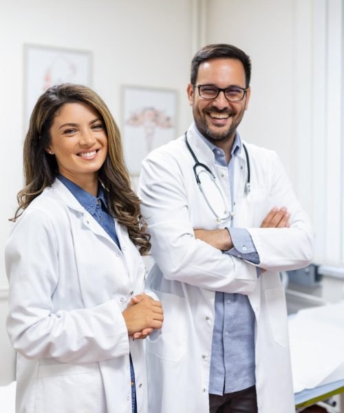 portrait-smiling-young-doctors-standing-together-portrait-medical-staff-inside-modern-hospital-smiling-camera
